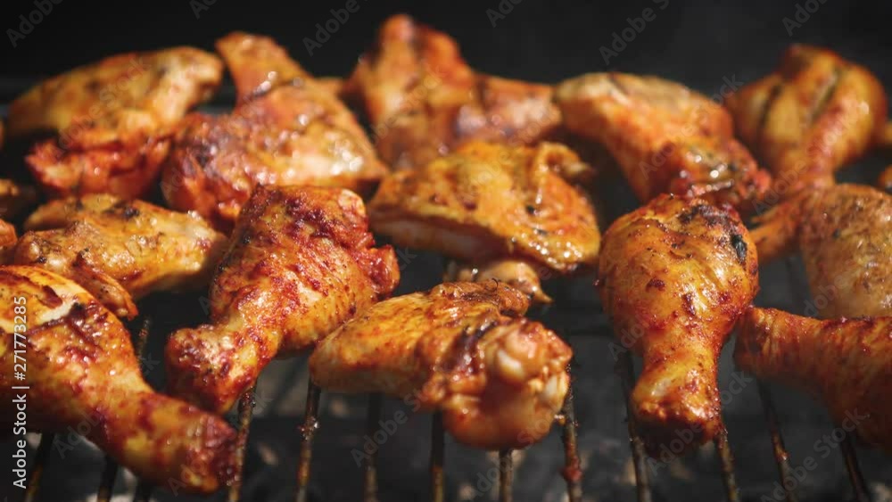 Delicious chicken pieces frying on barbecue grill Delicious chicken pieces frying on barbecue grill