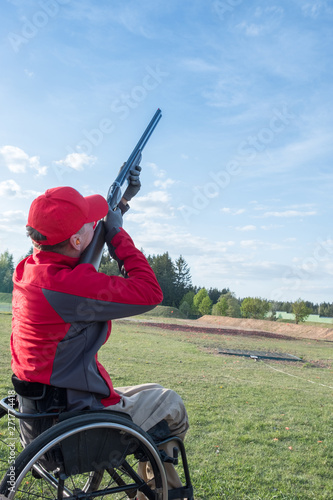 disabled person shoots skeet with a shotgun photo