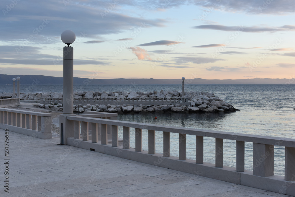 View of the embankment along the Adriatic Sea without people. Pleasant evening for walking. Classic Mediterranean promenade. Croatia.