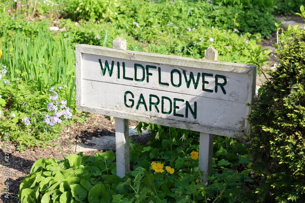 A close view of the old wood wildflower garden sign.