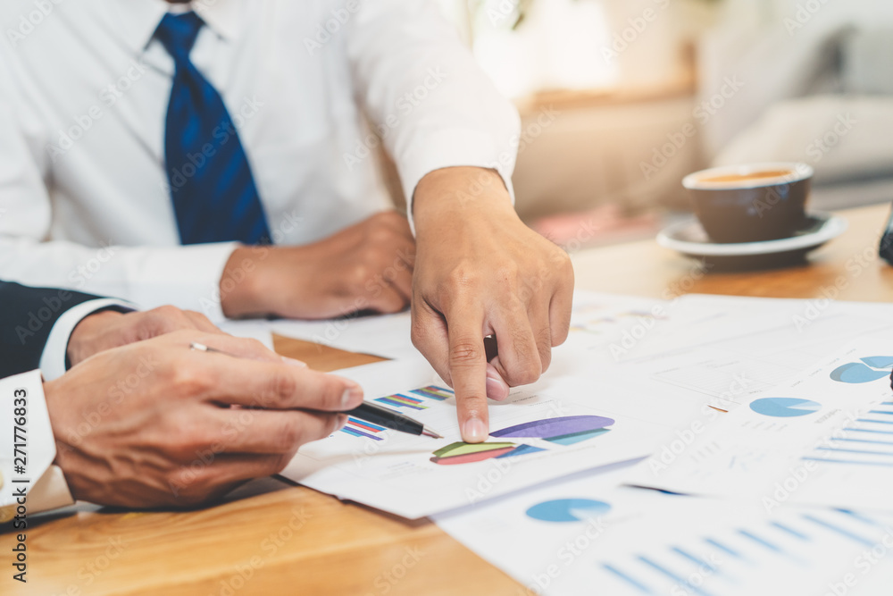 Close up view of businessman and finance consultant reviewing document for tax. Close up view of businessman and finance consultant reviewing document for tax.