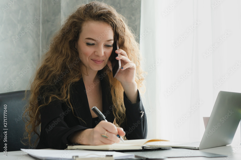 Businesswoman talking on mobile phone with partner at home office. Businesswoman talking on mobile phone with partner at home office.