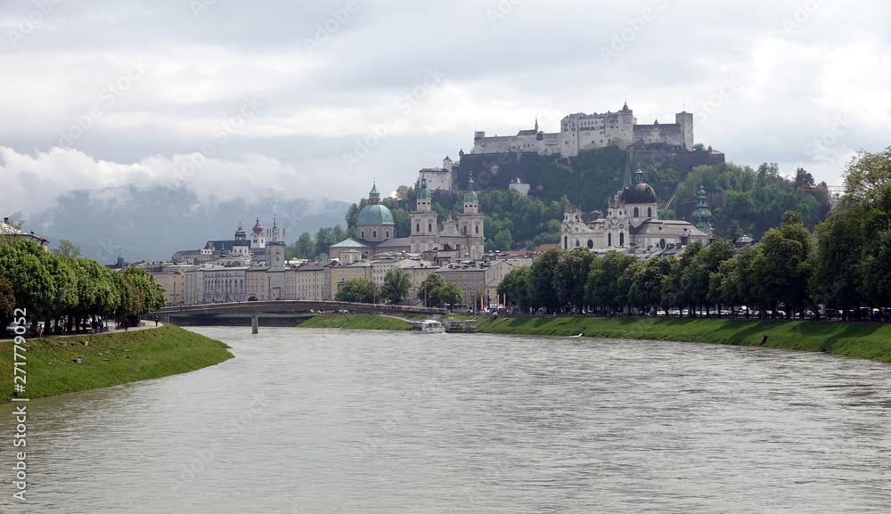 Landscape, with Hohensalzburg castle on Festung mountain in Salzburg, Austria. View from the bridge on Salzach river in overcast weather