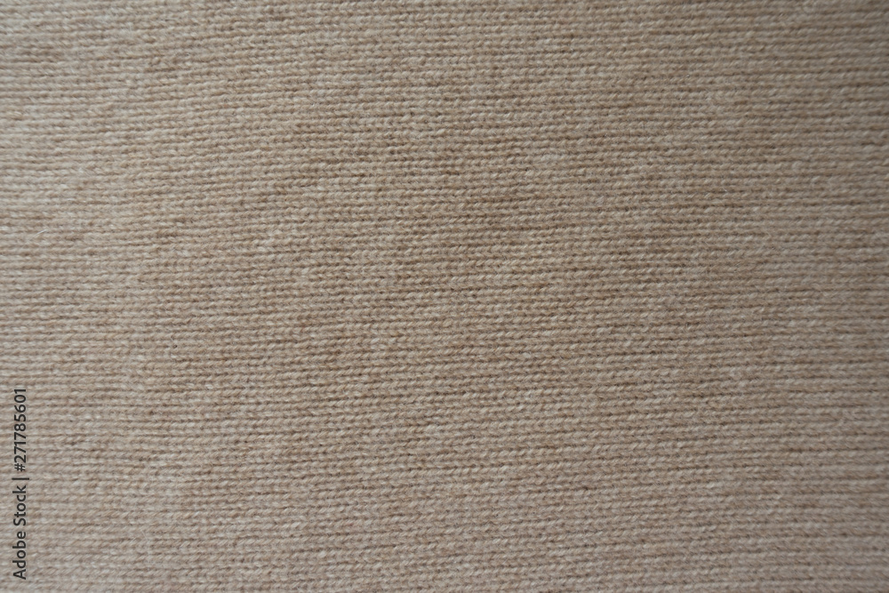 Background - simple beige knitted fabric from above Background - simple beige knitted fabric from above