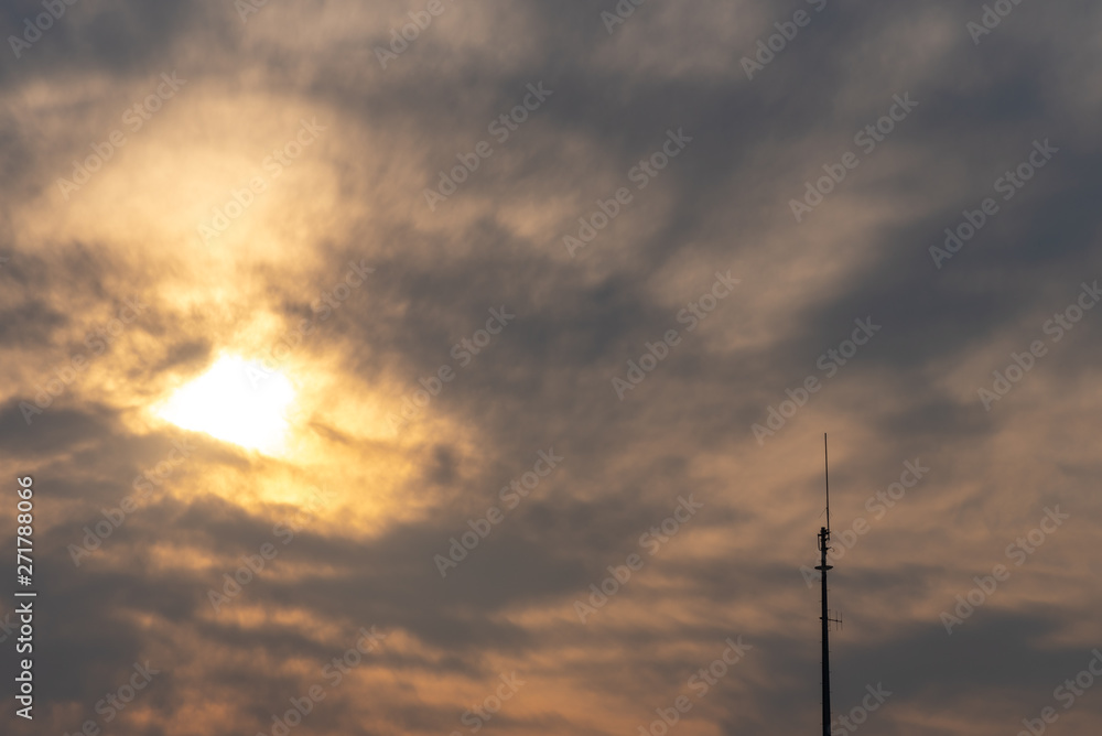 Silhouette view of antenna under twilight cloudy sky 