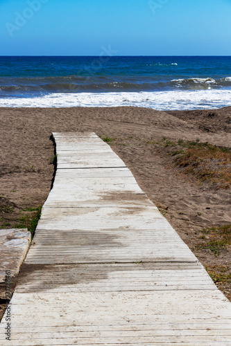 Wooden footpath at an empty Torre de Benagalbon beach  Province of Malaga  Andalusia  Spain