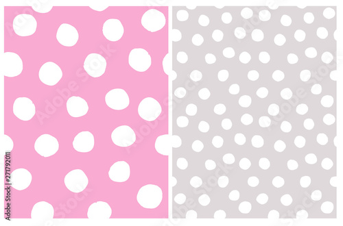 Cute Abstract Geometric Seamless Vector Patterns Set. Irregular Polka Dots Repeatable Design. White Dots on a Gray and Light Pink Backgrounds. Simple Dotted Layouts.