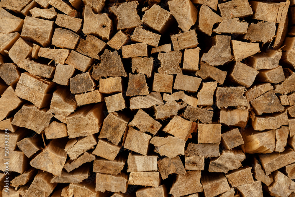 The texture of wooden firewood, randomly split and laid in straight rows The texture of wooden firewood, randomly split and laid in straight rows