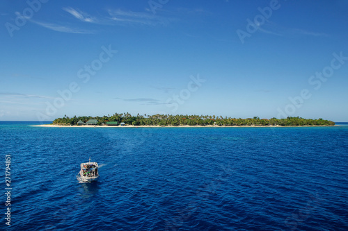 Boat going from South Sea Island in Mamanuca Island group, Fiji photo