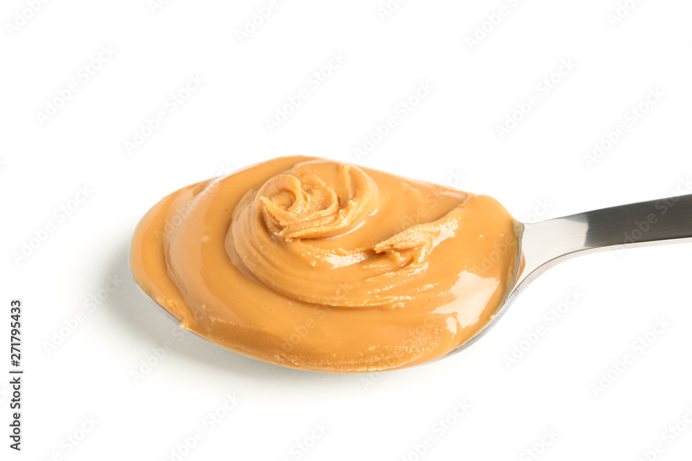 Creamy peanut butter in spoon isolated on white background, closeup. A traditional product of American cuisine Creamy peanut butter in spoon isolated on white background, closeup. A traditional product of American cuisine