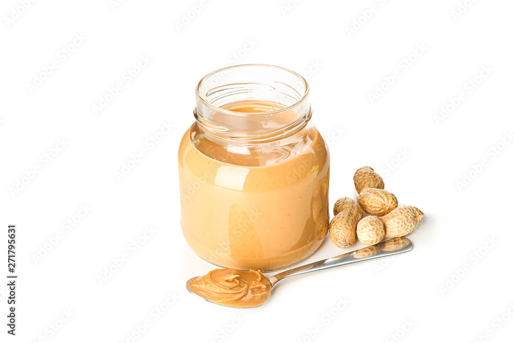 Creamy peanut butter in glass jar, peanut and spoon isolated on white background. A traditional product of American cuisine Creamy peanut butter in glass jar, peanut and spoon isolated on white background. A traditional product of American cuisine