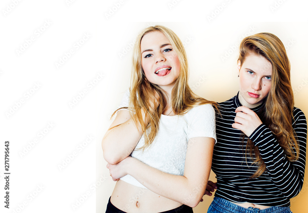 lifestyle and people concept: Fashion portrait of two stylish sexy girls best friends, over white background. Happy time for fun. One with hard feelings lifestyle and people concept: Fashion portrait of two stylish sexy girls best friends, over white background. Happy time for fun. One with hard feelings