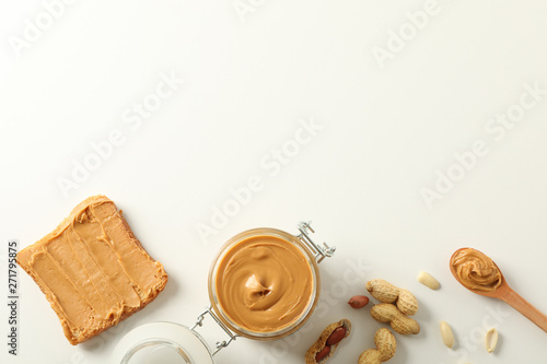 Obraz na plátně Flat lay composition with peanut butter sandwich, glass jar, peanut and spoon on