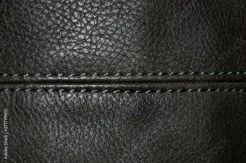 White stitched seam on black leather