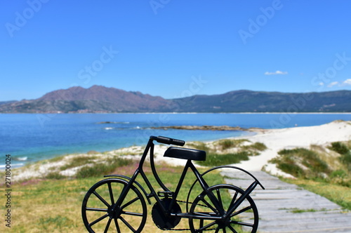Spain. Beach with black iron bicycle.