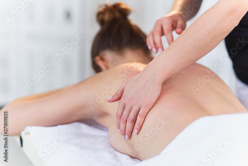Young sport woman during treatment massage in the clinic.