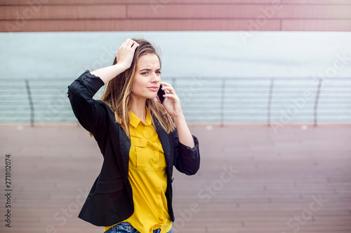 Worried woman talks on the ...