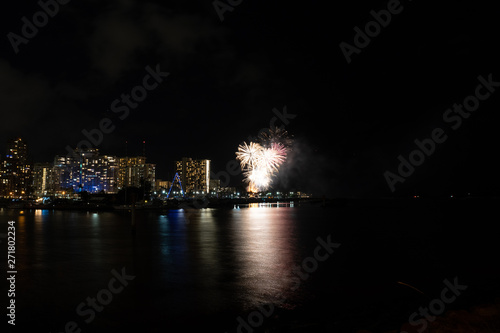 Friday night fireworks at Waikiki Beach, Honolulu cityscape at night, with negative space of blackness.