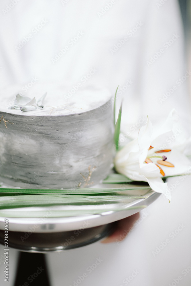 white wedding cake on a plate with flowers white wedding cake on a plate with flowers
