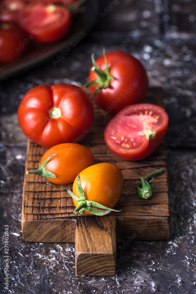 Still life of ripe tomatoes on wooden board Still life of ripe tomatoes on wooden board