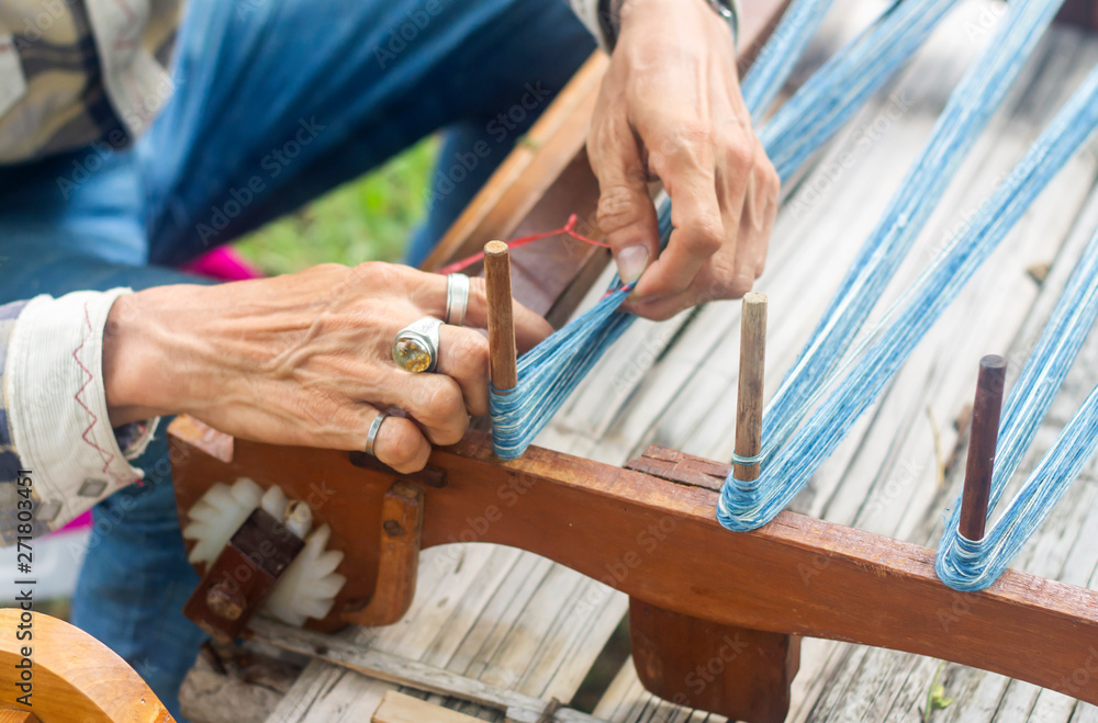 Thai style traditional hand-weaving loom being used to make cloth