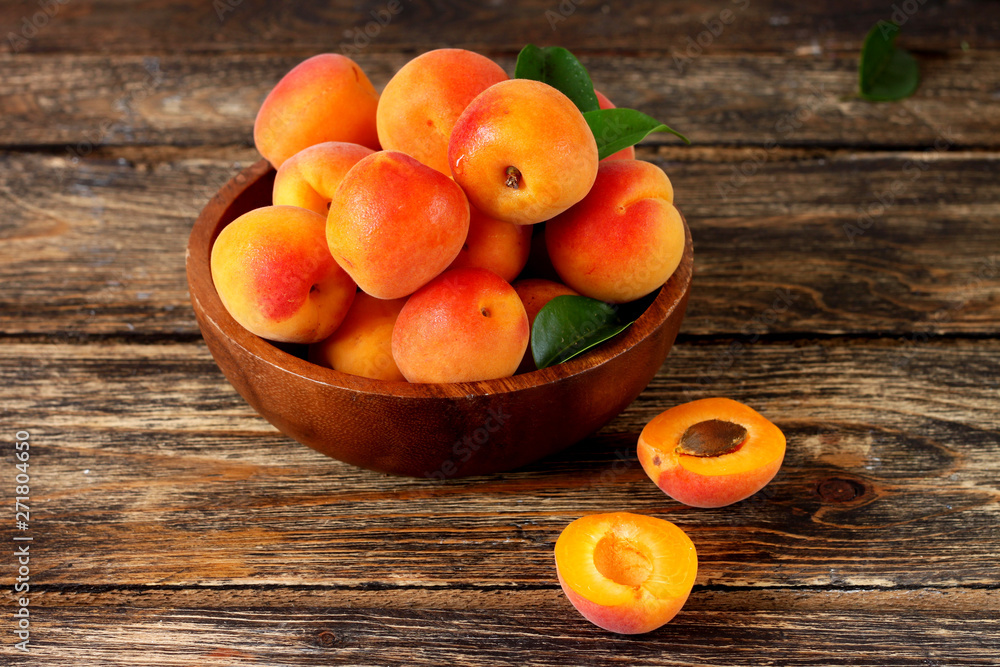 apricots in a bowl on wooden table apricots in a bowl on wooden table