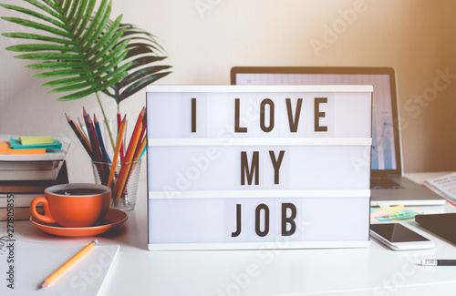 I love my job concepts with text on light box on desk table in home office photo