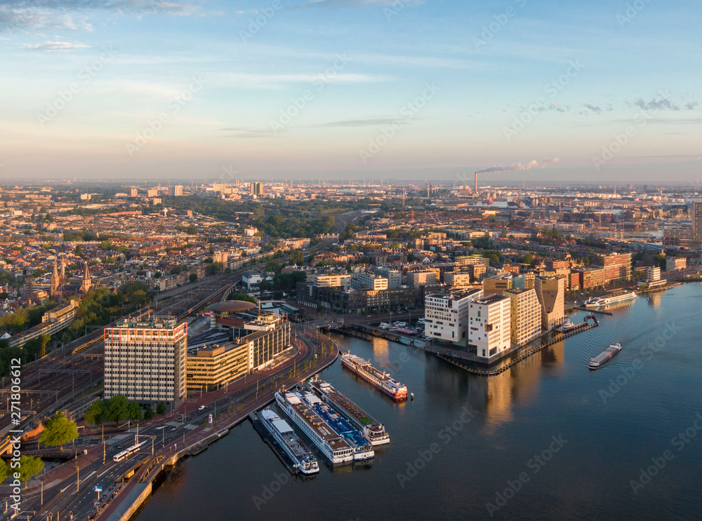 Aerial view of central part of Amsterdam, new district of IJdock and canal cruise ships, Netherlands