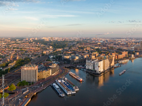 Aerial view of central part of Amsterdam  new district of IJdock and canal cruise ships  Netherlands