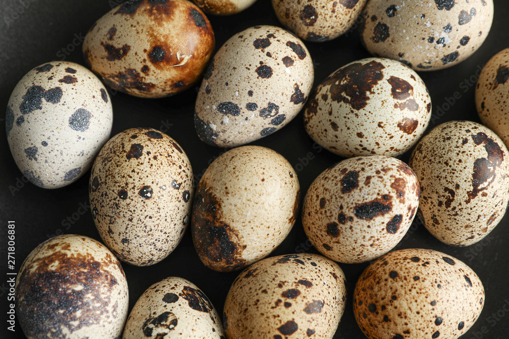 Many quail eggs on black background, closeup Many quail eggs on black background, closeup