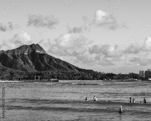 Diamond Head Crater taken from Magic Island, color and Black and white, surfers in wait puff-clouds kissing the crater