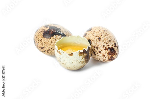 Quail eggs and half broken egg with yolk isolated on white background