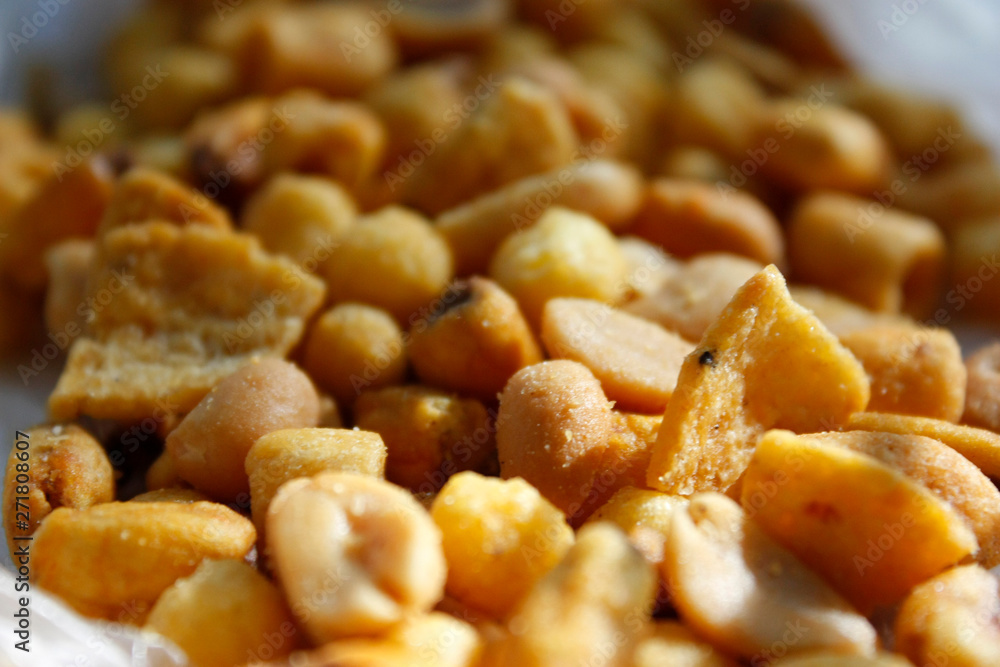 Golden mixed nuts, snacks, chips for beer close-up with selective focus. Golden mixed nuts, snacks, chips for beer close-up with selective focus.