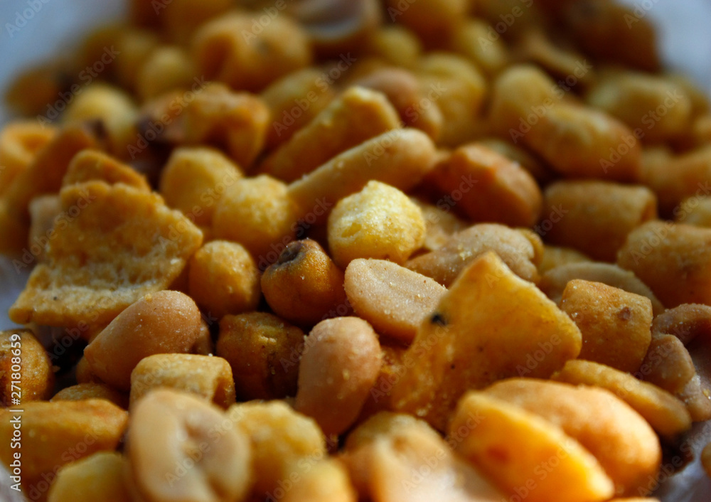 Golden mixed nuts, snacks, chips for beer close-up with selective focus. Golden mixed nuts, snacks, chips for beer close-up with selective focus.
