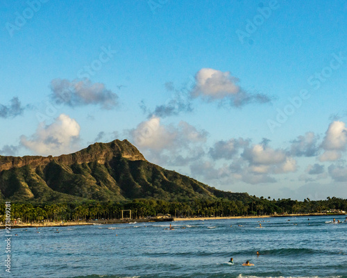 Diamond Head Crater taken from Magic Island, color and Black and white, surfers in wait puff-clouds kissing the crater