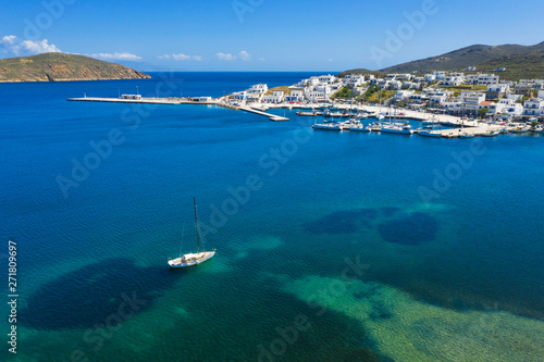 aerial view to alone yacht at the sea in front of harbor on greek island © sergejson