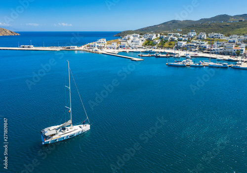 drone view to yacht that goes into harbor on greek island © sergejson