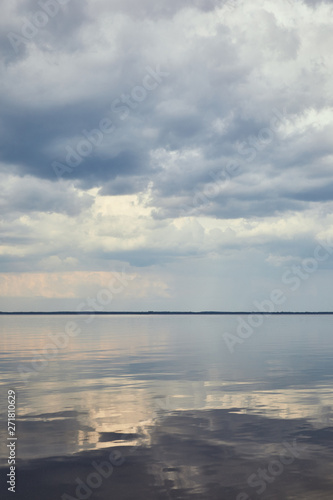 Blue peaceful sky with white clouds over river © LIGHTFIELD STUDIOS