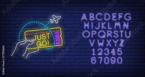 Just Go neon lettering and hand holding flight ticket. Tourism, vacation and travel design. Night bright neon sign, colorful billboard, light banner. Vector illustration in neon style.