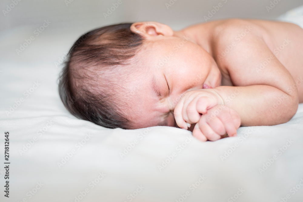 cute newborn baby is sleeping on white bed cute newborn baby is sleeping on white bed