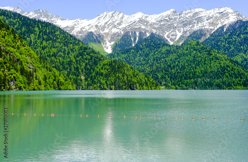 View of lake Ritsa (Riza) in Abkhazia in the spring, in the background snow-capped mountains