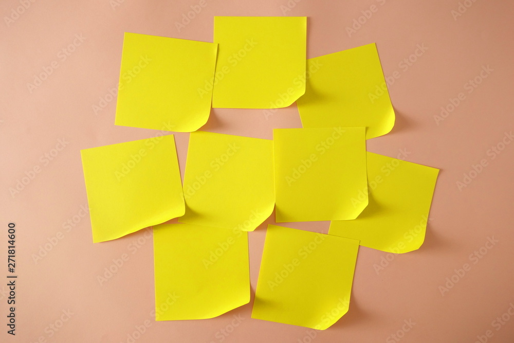 Fototapeta premium Yellow sticky notes with curled corner on pink background, copy space for design