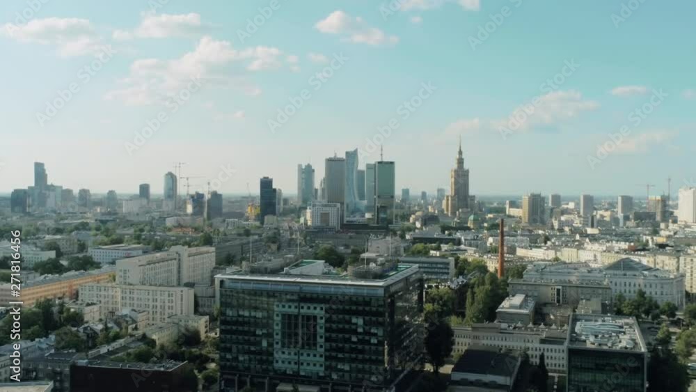 Aerial View of Warsaw City - Capital of Poland - with Skyscrapers, Palace of Culture and Science and Office Buildings on Summer Day. 4K Drone Pan Shot Aerial View of Warsaw City - Capital of Poland - with Skyscrapers, Palace of Culture and Science and Office Buildings on Summer Day. 4K Drone Pan Shot