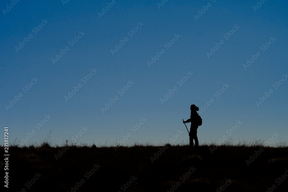 silhouette of man running on country road