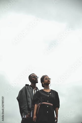 man and woman standing under clear skies photo