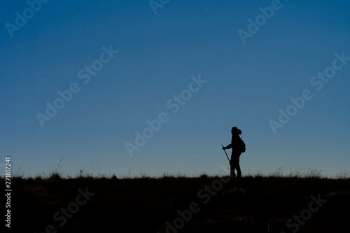silhouette of man running on country road