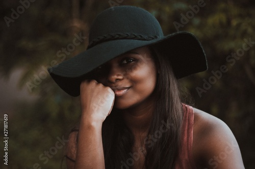 smiling woman wearing black hat