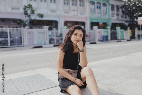 woman sitting on pavement