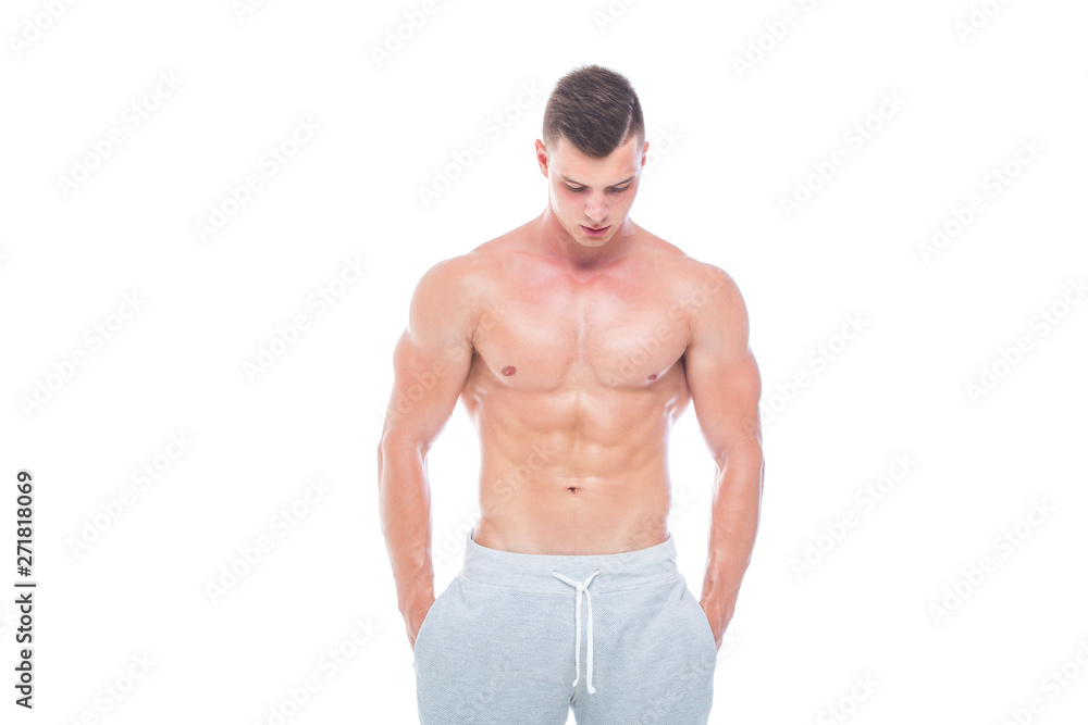 Strong Athletic Man - Fitness Model showing his perfect body isolated on white background with copyspace. Bodybuilder man with perfect abs, shoulders,biceps, triceps and chest.