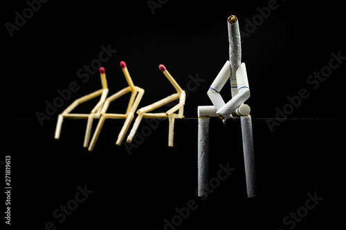 Concept of bad company. We are friends  a toxic friendship. Image of a character made of cigarette  with matchsticks next to it  on black background.